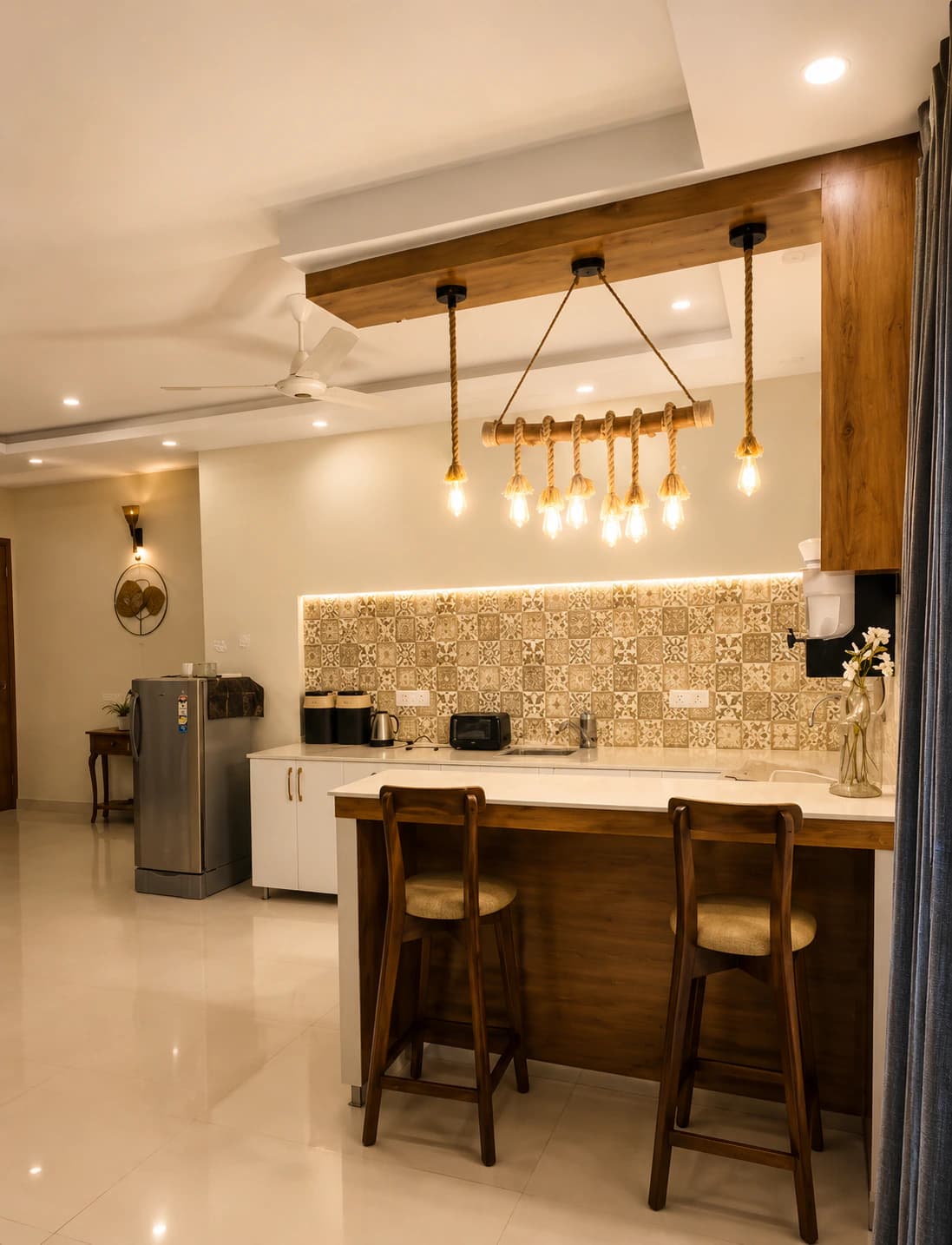 Open kitchen with a breakfast counter, bar stools, patterned tile splashback and rope pendant lighting